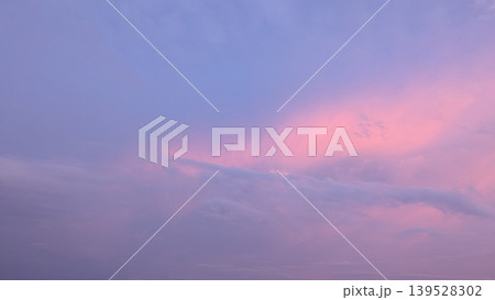 A serene twilight sky is saturated with vibrant pink, purple, lavender tones. The colors blend into soft blue on the upper left, creating a beautiful, ethereal, expansive nature background. 139528302