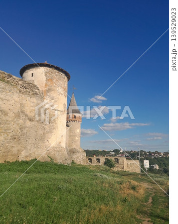 Ancient stone fortress wall under blue sky, historic architecture detail Ancient stone fortress wall under blue sky, historic architecture detail 139529023
