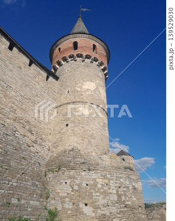 Ancient stone fortress wall under blue sky, historic architecture detail 139529030