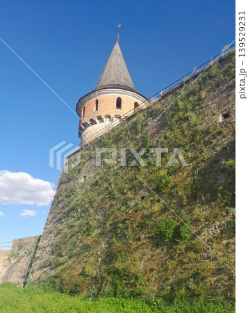 Ancient stone fortress wall under blue sky, historic architecture detail Ancient stone fortress wall under blue sky, historic architecture detail 139529231
