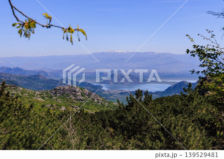 Panoramic Mountain and Lake Landscape With Forested Hills, Snowcapped Peaks and Serene Blue Water View Panoramic Mountain and Lake Landscape With Forested Hills, Snowcapped Peaks and Serene Blue Water View 139529481