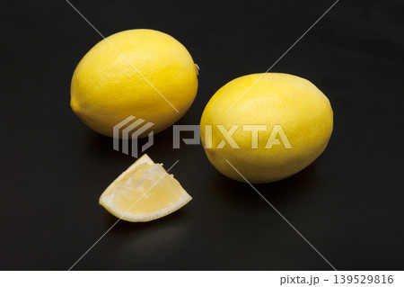 Fresh yellow lemons on a black background Fresh yellow lemons on a black background 139529816