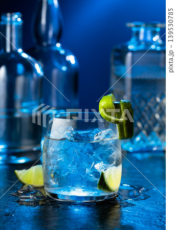 Vodka with lime and ice cubes in a fogged up glass. Vodka with lime and ice cubes in a fogged up glass. 139530785