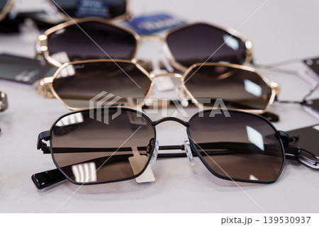 Close-up of stylish sunglasses displayed on white surface with tags Close-up of stylish sunglasses displayed on white surface with tags 139530937