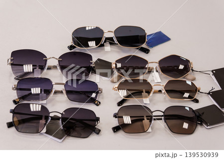 Collection of modern fashion eyewear sunglasses with gold acetate frames arranged on white background studio photography Collection of modern fashion eyewear sunglasses with gold acetate frames arranged on white background studio photography 139530939