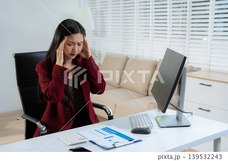 Tired asian businesswoman with headache at office, feeling sick at work. Tired asian businesswoman with headache at office, feeling sick at work. 139532243