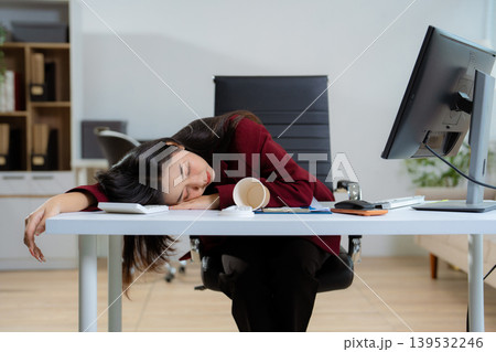 Asian businesswoman works at home office until her body is tired, she is drowsy during the daytime. female wants to sleep during the day concept. Asian businesswoman works at home office until her body is tired, she is drowsy during the daytime. female wants to sleep during the day concept. 139532246