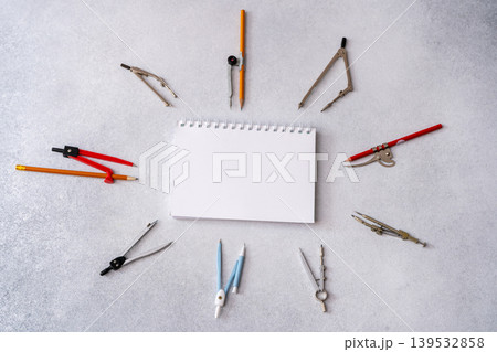 Drawing compass Tools Supplies arranged around Paper copy space. School table top view 139532858