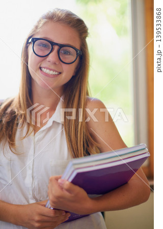 Happy woman, portrait and student with books and glasses at school hallway for education, study or learning. Young female person, teenager or nerd smile with textbooks for knowledge in corridor Happy woman, portrait and student with books and glasses at school hallway for education, study or learning. Young female person, teenager or nerd smile with textbooks for knowledge in corridor 139533868