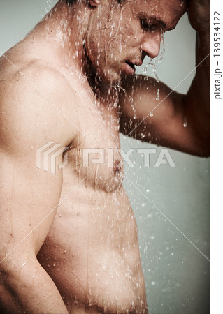 Man in shower thinking, cleaning hair and body for morning wellness, hygiene and skin routine. Grooming, skincare and male model with muscle washing with water, self care and relax in calm bathroom. Man in shower thinking, cleaning hair and body for morning wellness, hygiene and skin routine. Grooming, skincare and male model with muscle washing with water, self care and relax in calm bathroom. 139534122