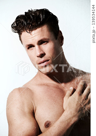 Shower, hot and body of man with water for washing, cleaning and skincare wellness. Young, sexy and muscular male model person with grooming and hygiene for healthy skin by white studio background. 139534144