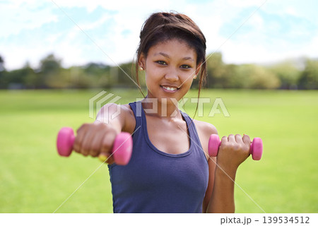 Woman, portrait and dumbbells outdoor for training with smile for workout, exercise or fitness on sports field. Athlete, person and happy for physical activity or healthy body on grass with equipment Woman, portrait and dumbbells outdoor for training with smile for workout, exercise or fitness on sports field. Athlete, person and happy for physical activity or healthy body on grass with equipment 139534512