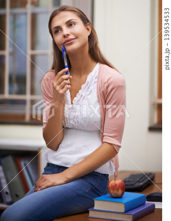 School teacher, woman thinking and planning in classroom, brainstorming and ideas for education. Female person, knowledge and information for learning, contemplating academic and smiling for career School teacher, woman thinking and planning in classroom, brainstorming and ideas for education. Female person, knowledge and information for learning, contemplating academic and smiling for career 139534533