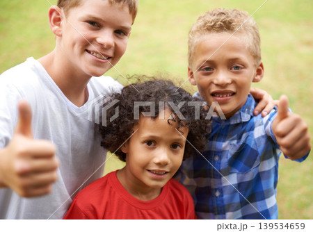 Happy children, portrait and thumbs up for outdoor teamwork, winning or good job together in nature. Group of casual young boys smile and hug with like emoji, yes sign or OK for success at the park 139534659