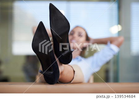 Woman, heels and relax on table in office with smile, pride of done with goal, relief or fashion at finance agency. Person, employee and happy with shoes on desk, finished or achievement in workplace Woman, heels and relax on table in office with smile, pride of done with goal, relief or fashion at finance agency. Person, employee and happy with shoes on desk, finished or achievement in workplace 139534684