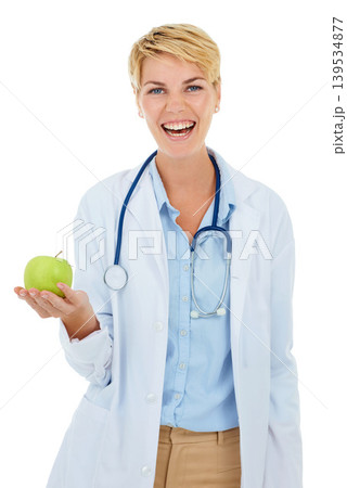 Doctor, woman in portrait and apple for health and diet with nutritionist in studio, smile and wellness on white background. Healthy food, medical professional with fruit for nutrition or weightloss 139534877