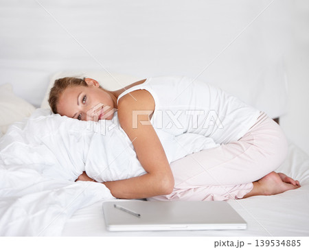 Woman, remote work and relax in portrait on bed with happiness, comfort and pillow. Morning, bedroom and calm person hugging duvet with a smile for nap or rest in apartment with project and laptop Woman, remote work and relax in portrait on bed with happiness, comfort and pillow. Morning, bedroom and calm person hugging duvet with a smile for nap or rest in apartment with project and laptop 139534885