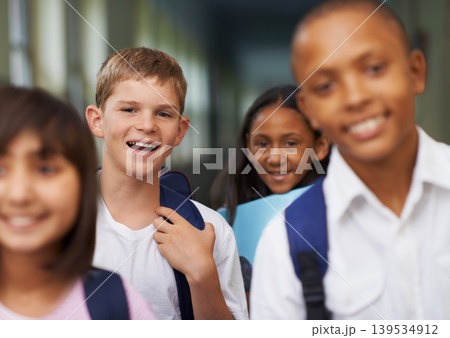 Friends, portrait and happy in corridor of school with backpack for learning, education and knowledge. Student, person and face with smile in building before class or ready to study with diversity 139534912