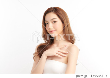 A beautiful young Asian woman with clean, fresh skin against a white background. Skincare, facial treatment, cosmetology, beauty, and spa. An elegant portrait of an Asian woman. 139535103