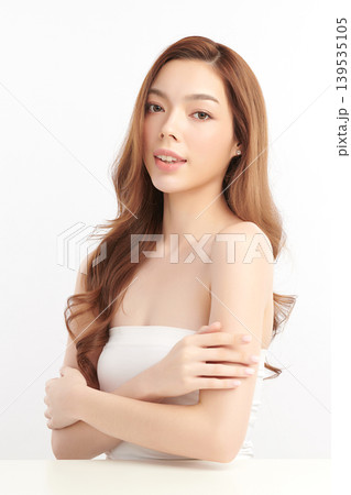 A beautiful young Asian woman with clean, fresh skin against a white background. Skincare, facial treatment, cosmetology, beauty, and spa. An elegant portrait of an Asian woman. A beautiful young Asian woman with clean, fresh skin against a white background. Skincare, facial treatment, cosmetology, beauty, and spa. An elegant portrait of an Asian woman. 139535105