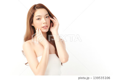 A beautiful young Asian woman with clean, fresh skin against a white background. Skincare, facial treatment, cosmetology, beauty, and spa. An elegant portrait of an Asian woman. A beautiful young Asian woman with clean, fresh skin against a white background. Skincare, facial treatment, cosmetology, beauty, and spa. An elegant portrait of an Asian woman. 139535106