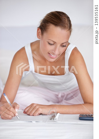 Happy woman, writing and documents in bed for budget planning, expenses or finance at home. Female person smile with notebook or calculator for morning or financial checklist in bedroom at house 139535161