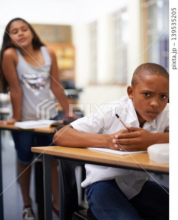Portrait, copy or students cheating in exam with paper, school corruption or education fraud. Cover, girl peeking or smart male child learner hiding or writing answers in test in classroom at desk 139535205