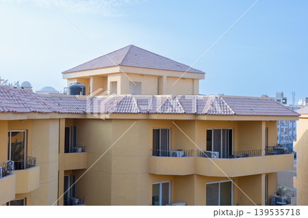 Apartment complex with yellow walls and tiled roofs on October 1, 2023 in Hurghada, Egypt Apartment complex with yellow walls and tiled roofs on October 1, 2023 in Hurghada, Egypt 139535718