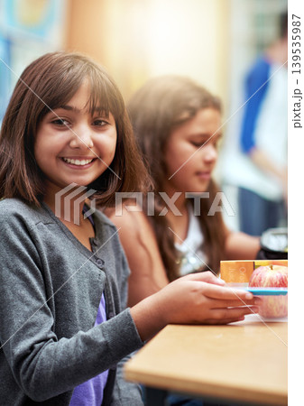 Girl, happy and portrait with lunch at school for recess, break or nutrition at table with meal. Kid, face and smile at academy or relax with confidence, food or pride for childhood development 139535987