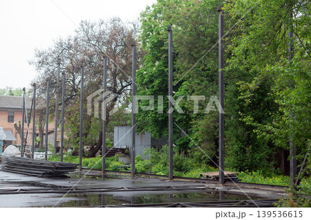 Row of vertical steel pillars at an outdoor construction site for a new industrial building or warehouse frame. Row of vertical steel pillars at an outdoor construction site for a new industrial building or warehouse frame. 139536615