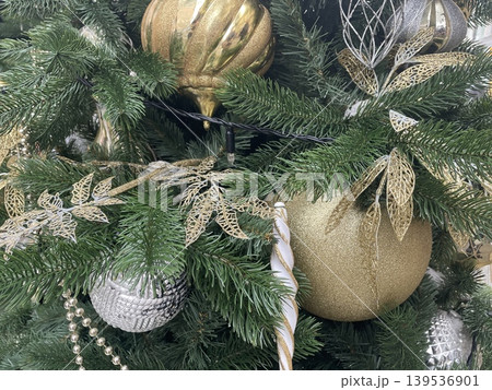 Christmas tree decorated with elegant gold and silver ornaments, balls, and fir branches Christmas tree decorated with elegant gold and silver ornaments, balls, and fir branches 139536901