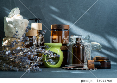 Scented candles and jars with essential oil. Dried lavender flowers. Aromatherapy Scented candles and jars with essential oil. Dried lavender flowers. Aromatherapy 139537061