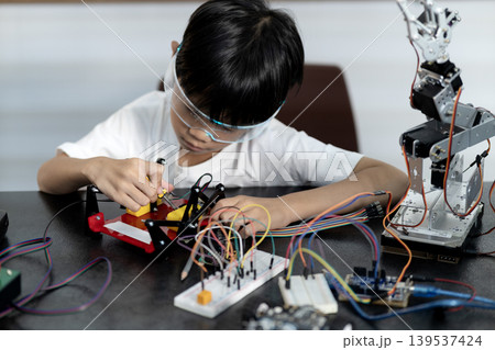 Asian boy is paying attention and adding and improving Asian boy is paying attention and adding and improving 139537424