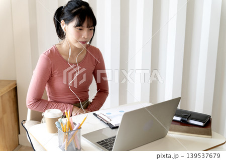 Young teenage woman is communicating or studying Young teenage woman is communicating or studying 139537679