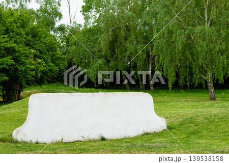 White concrete bench on green grass in park White concrete bench on green grass in park 139538158
