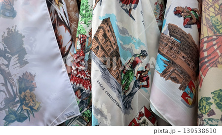 Printed souvenir scarves with spanish landmarks and flamenco motifs for travel souvenir display and textile pattern design background. Feria La Vaquilla, Colmenar Viejo, Spain 139538610