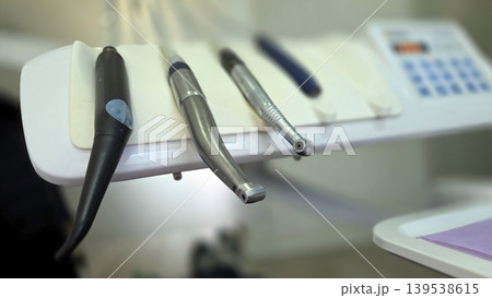 Closeup dental handpiece and instrument tray for clinic equipment background and procedure detail banner Closeup dental handpiece and instrument tray for clinic equipment background and procedure detail banner 139538615
