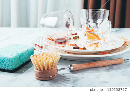 wooden round brush with bristles, for washing dishes, close-up, dirty dishes in the background, cleaning, concept, wooden round brush with bristles, for washing dishes, close-up, dirty dishes in the background, cleaning, concept, 139538727