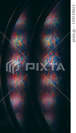 Oil spill. Psychedelic texture. Defocused blue purple orange color ink chemical round drop floating on abstract dark black background. 139539022