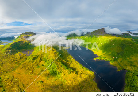 Aerial view of misty mountains and fjords in Lofoten, Norway.  139539202