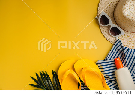 Summer holiday flat lay yellow background. Beach travel accessories for vacation. Sunglasses, sun hat, sunscreen. Copy space Summer holiday flat lay yellow background. Beach travel accessories for vacation. Sunglasses, sun hat, sunscreen. Copy space 139539511
