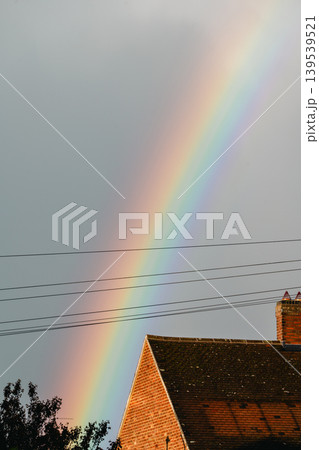 Double rainbow on a gray sky after rain and storm. Real rainbow after rain on a spring day. Double rainbow on a gray sky after rain and storm. Real rainbow after rain on a spring day. 139539521