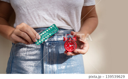 woman holding 21 day oral contraceptive pills, birth control and pregnancy planning 139539629