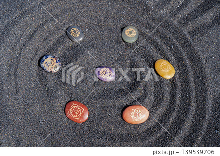 Healing crystals on black sand background Healing crystals on black sand background 139539706