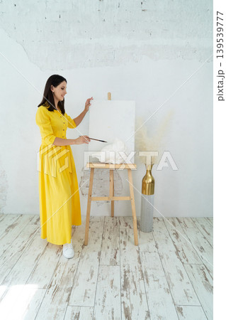 A Joyful Artist Proudly Showcasing Their Colorful Paint Brushes in a Bright and Inspiring Studio Environment A Joyful Artist Proudly Showcasing Their Colorful Paint Brushes in a Bright and Inspiring Studio Environment 139539777