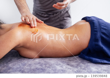 Asian woman receiving a relaxing massage with aromatic oil in a serene spa environment, showcasing tranquility and wellness through professional therapy techniques 139539848