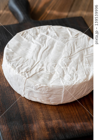 Whole Camembert Cheese Wheel Resting On Dark Rustic Wooden Serving Board Elegantly 139539996