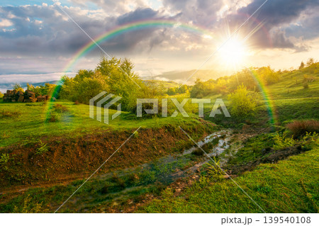foggy sunset over carpathian mountain landscape. outdoor adventure with stunning view in evening light. countryside landscape with rolling hills, fog and cloudy sky. weather with rainbow foggy sunset over carpathian mountain landscape. outdoor adventure with stunning view in evening light. countryside landscape with rolling hills, fog and cloudy sky. weather with rainbow 139540108