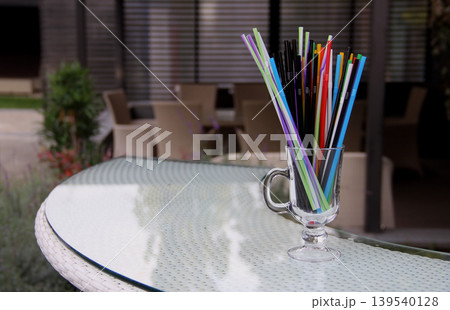 Colorful drinking straws in glass on the bar at the resting area Colorful drinking straws in glass on the bar at the resting area 139540128