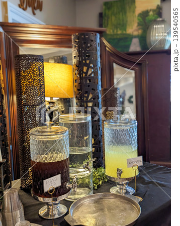 Beverage Station with Glass Drink Dispensers and Refreshments Setup on Table in Event Beverage Station with Glass Drink Dispensers and Refreshments Setup on Table in Event 139540565
